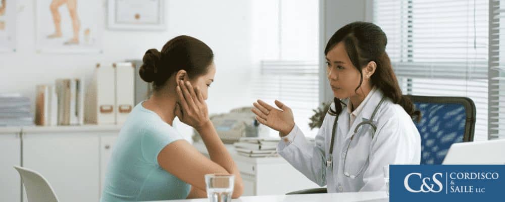 Brain injury doctor talking to a female patient