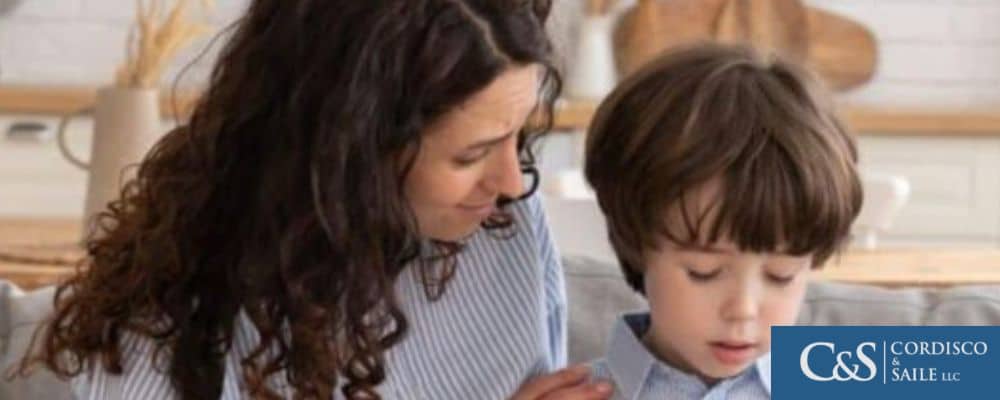 Parent sitting with and talking to a worried child