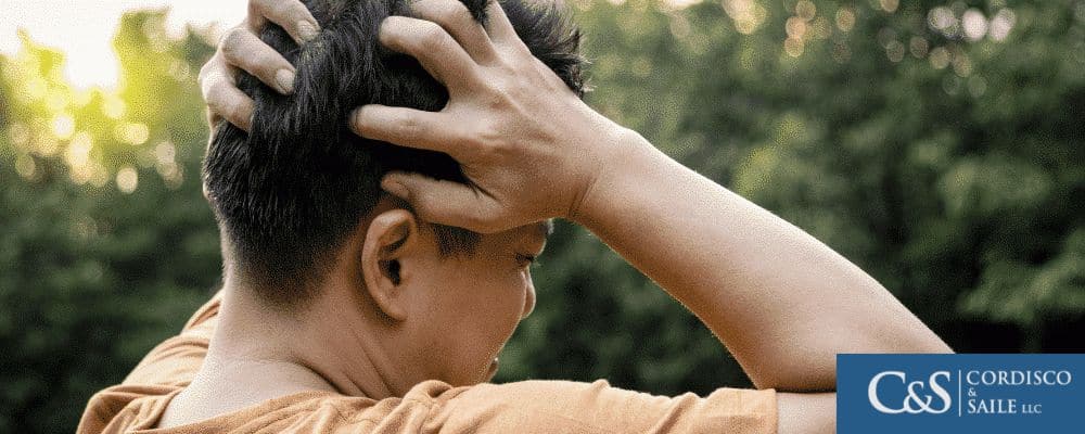 Young man holding his head in anguish