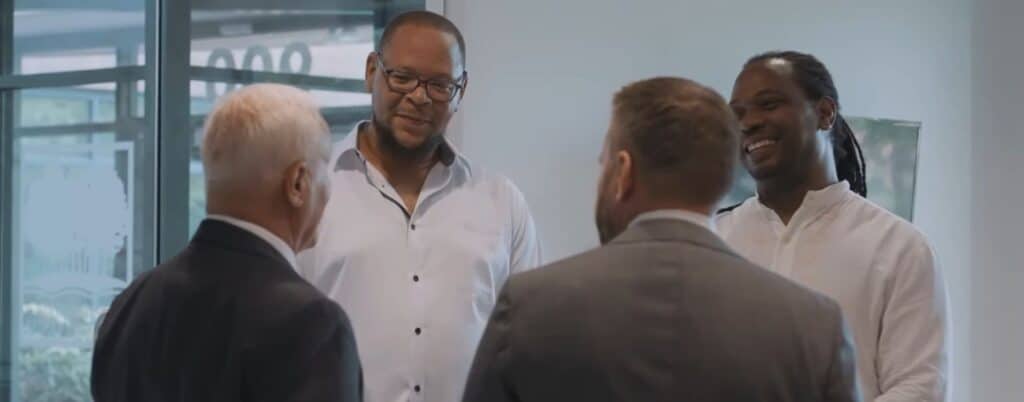 attorneys talking to clients in firm lobby