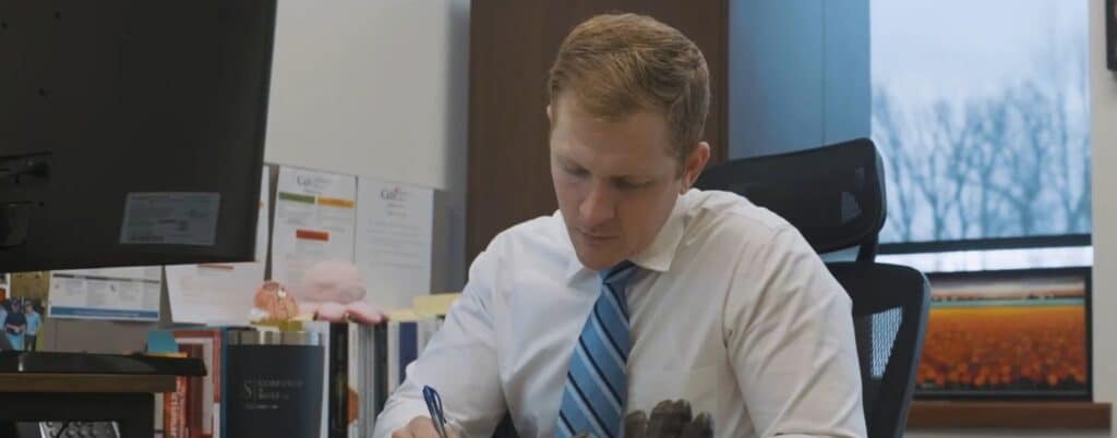 lawyer taking notes while sitting at office desk