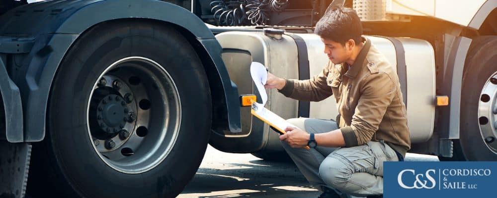 inspector examining truck to ensure it meets regulations