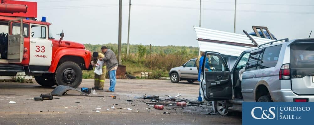 people standing in street after a truck accident